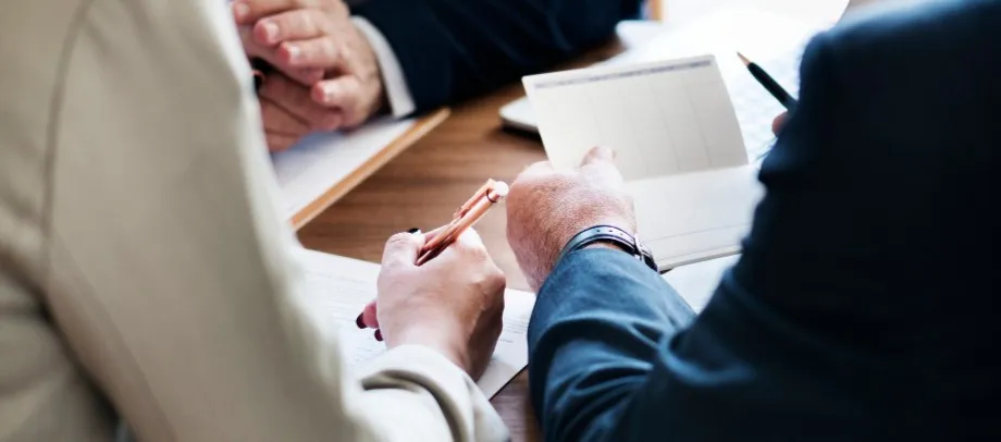 Personas revisando documentos en una reunión para entender qué es un recurso de alzada en el ámbito administrativo.
