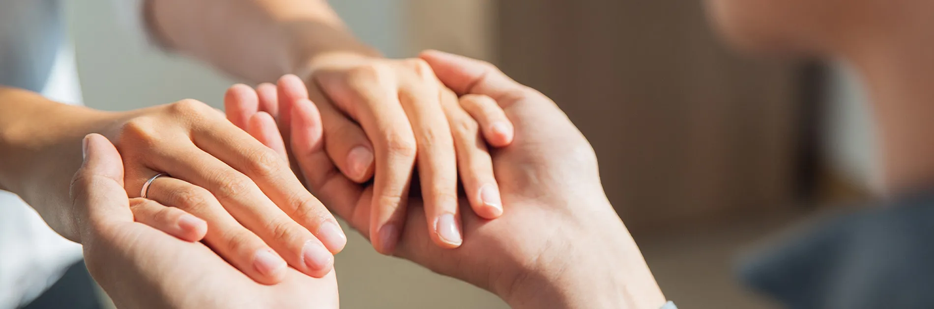 Manos entrelazadas representando la terapia de aceptación y compromiso